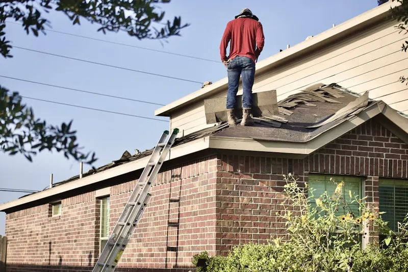Professional roofer working on a residential roof in West Greenville
